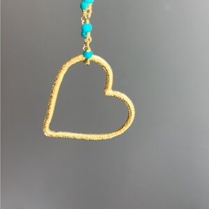 Brent Neale floating 18k heart is the only remaining piece in this group.